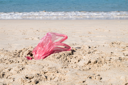 Used plastic bag on sand beachの写真素材