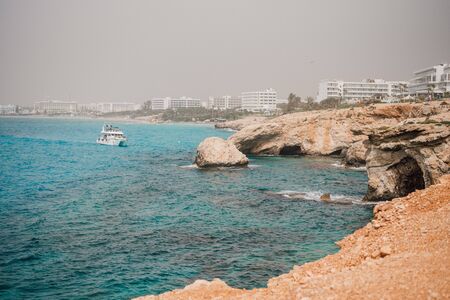 Cyprus. Ayia Napa. Love bridge. Rock arch in the sea. The Cape Greco . The Mediterranean sea picturesque coast. Natural attractions of Cyprus. Panorama of the Republic of Cyprus. Turquoise water.の写真素材