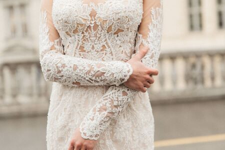 Bride hands on beautiful wedding dressの写真素材