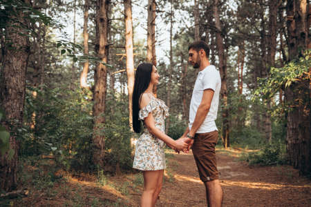Joyful couple hugging together on natural outdoors background. Romantic holiday date in the countryside. Emotional balance relaxing lifestyleの写真素材