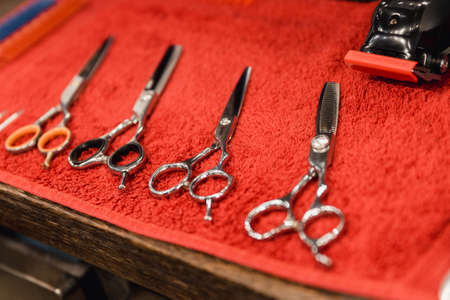 Barber tool in barbershop. Hairdresser tool. Scissors, combs, razors, clippers. Tool for the wizard. Organization of the workplace. Selective focusの写真素材