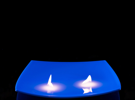 candle on blue backgroundの写真素材