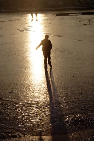 Silhouette of the girl on thin to ice of the riverの写真素材