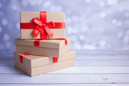 Pile of presents on wooden surface and bokeh background