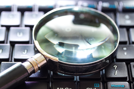 A magnifying Glass is searching the internet. Search engine optimization conceptの写真素材