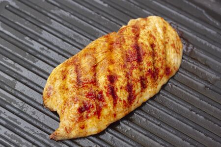 Chicken breast grilled with spices on panの写真素材