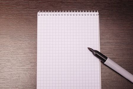 Notebook mockup with clean white blank for design and advertising. Notepad with marker chromed spring and free copy space template.の写真素材