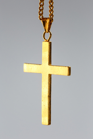 Golden cross pendant on the gold chain ( 24K pure gold necklace christian)の写真素材