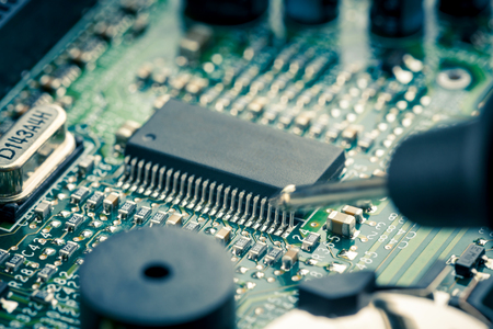 Close Up - Technician engineer measuring multimeter computer circuit board motherboard (Technology repairing computer Hardware)の写真素材