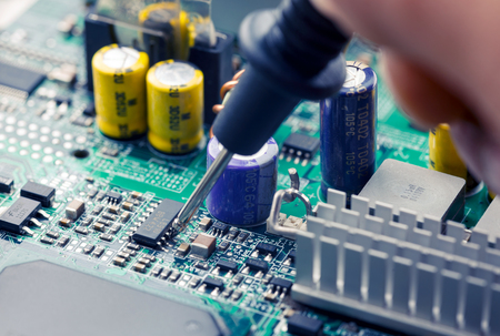 Close Up - Technician engineer measuring multimeter computer circuit board motherboard (Technology repairing computer Hardware)の写真素材
