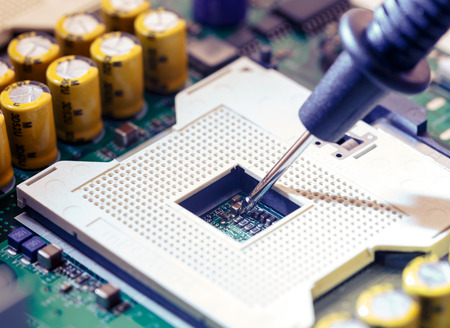 Close Up - Technician engineer measuring multimeter CPU socket computer motherboard (Technology repairing computer Hardware)の写真素材