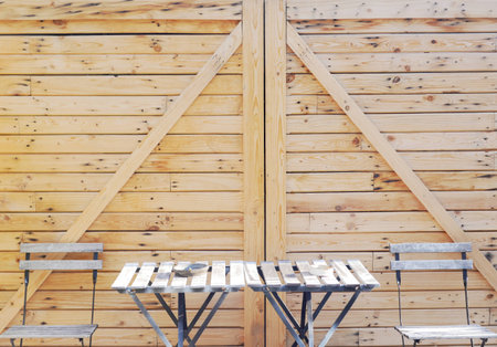 table, chairs and wood wall background