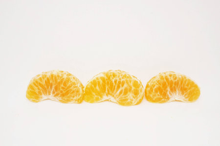 peeled orange on white background.の写真素材