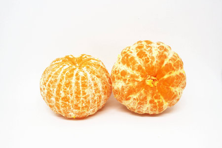 peeled oranges on white background.の写真素材