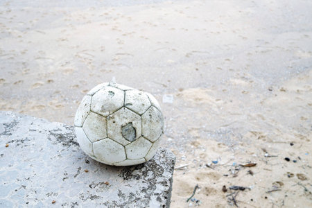 old football on the beach.の写真素材