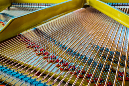 Close up of an antique grand piano showing the sounding board and strings.の写真素材