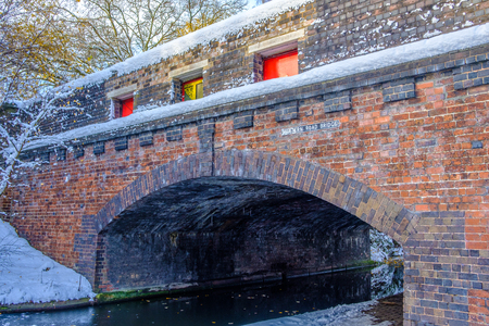 View of frozen Birmingham Canal and a bridge made of bricksの写真素材