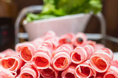 A plate of raw meat in a chinese hot pot restaurantの写真素材