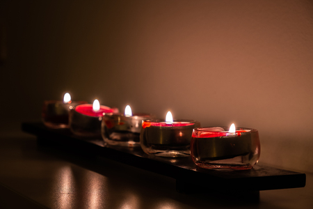A roll of small red candles as light source.の写真素材