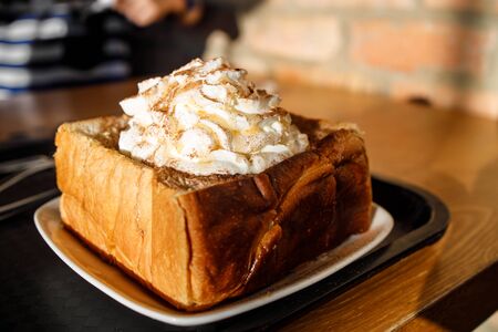 Korean styled french toast with wiped cream on top