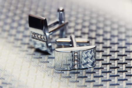 Pair of silver cuff links on the man's tieの写真素材
