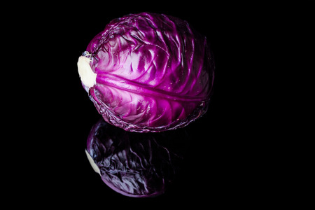 Purple cabbage head on black background with reflectionの写真素材