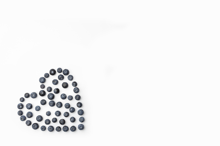 Blueberries heart in the corner on white background directly from aboveの写真素材