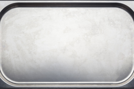 Stainless steel medical or kitchen tray with chamfered corners closeupの写真素材