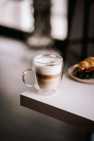 coffee and croissant on the tableの写真素材