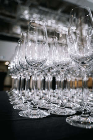 Empty wine glasses on a table in a restaurant. Close-up.の写真素材