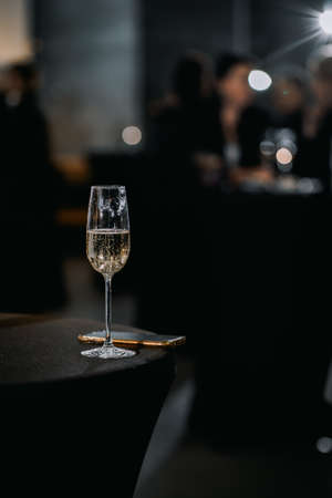 A glass of champagne on the table in a restaurant with a blurred backgroundの写真素材