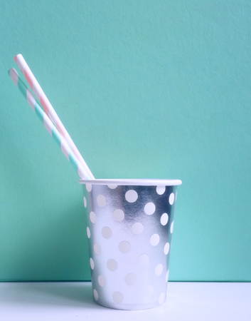 Party paper cup with two drinking straws for beverages. Vertical photoの写真素材