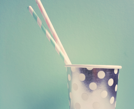 Party paper cup with two drinking straws for beveragesの写真素材