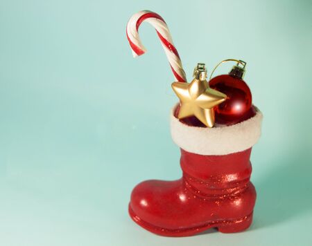Santa red boot with candy cane and baubles. Christmas. New Year background with copy space