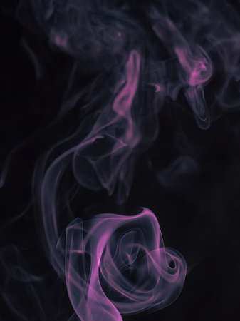 Close up movement of colorful smoke isolated on black background.Abstract background smoke curves and wave on black background.の写真素材