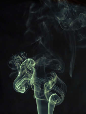 Close up movement of colorful smoke isolated on black background.Abstract background smoke curves...