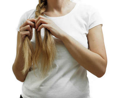 A girl with long white hair braids a braid. Long Hair Care and Hair Loss Treatment