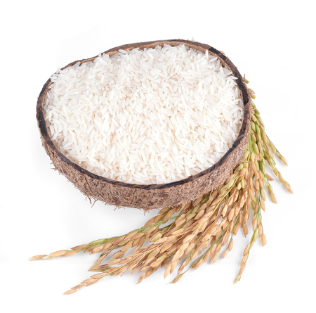 white rice on the wooden plate and rice plant , uncooked raw cerealsの写真素材