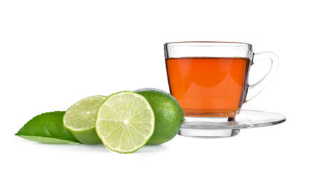 cup of tea  and lime slices on white backgroundの写真素材