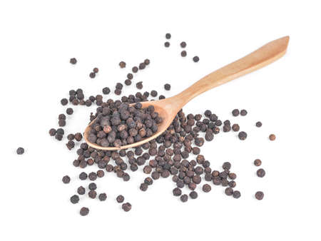 Black pepper in spoon wooden bowl isolated on white backgroundの写真素材