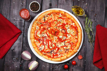 Vegetarian pizza with mushrooms, onions and bell peppersの写真素材