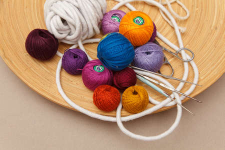 Funny multicolored woolen balls in wooden bowlの写真素材
