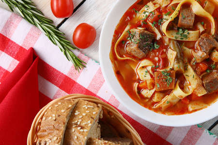 Traditional asian noodle soup with vegetables and meat, known as lagman. Oriental, uzbek style cuisine.の写真素材