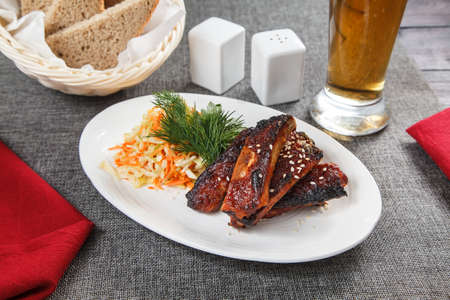 barbecued pork ribs on white plateの写真素材