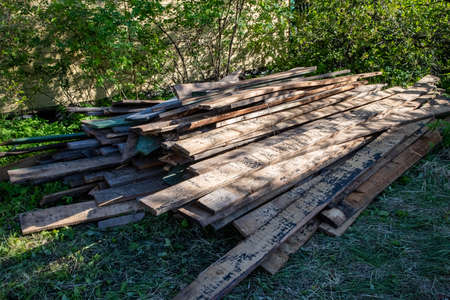 a pile of stacked old wooden planksの写真素材