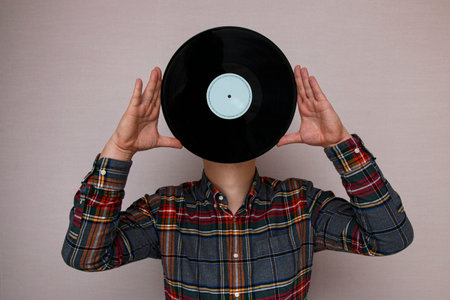 man with a vinyl record instead of a headの写真素材