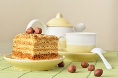 Honey cake with nuts and a cup of coffeeの写真素材