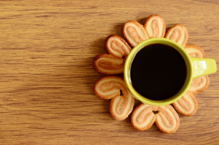 Cookies around a cup of coffee on a wooden backgroundの写真素材