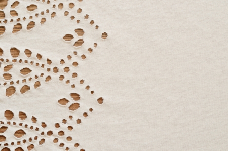 Background from beige knitted fabric with cuts