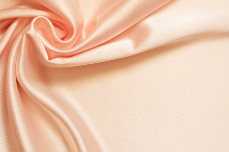 Peach background with satin drapery in the cornerの写真素材
